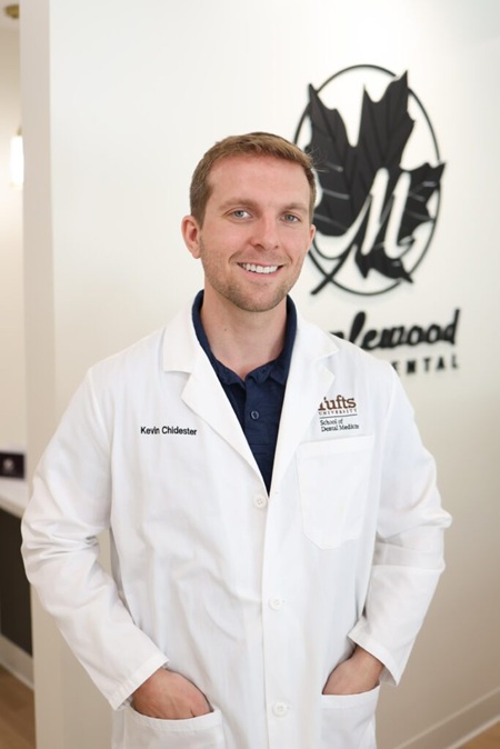 Portrait of Kevin Chidester, DMD standing in a dental office wearing a white coat, representing professional family dental care in Knightdale NC – Dentist Knightdale NC