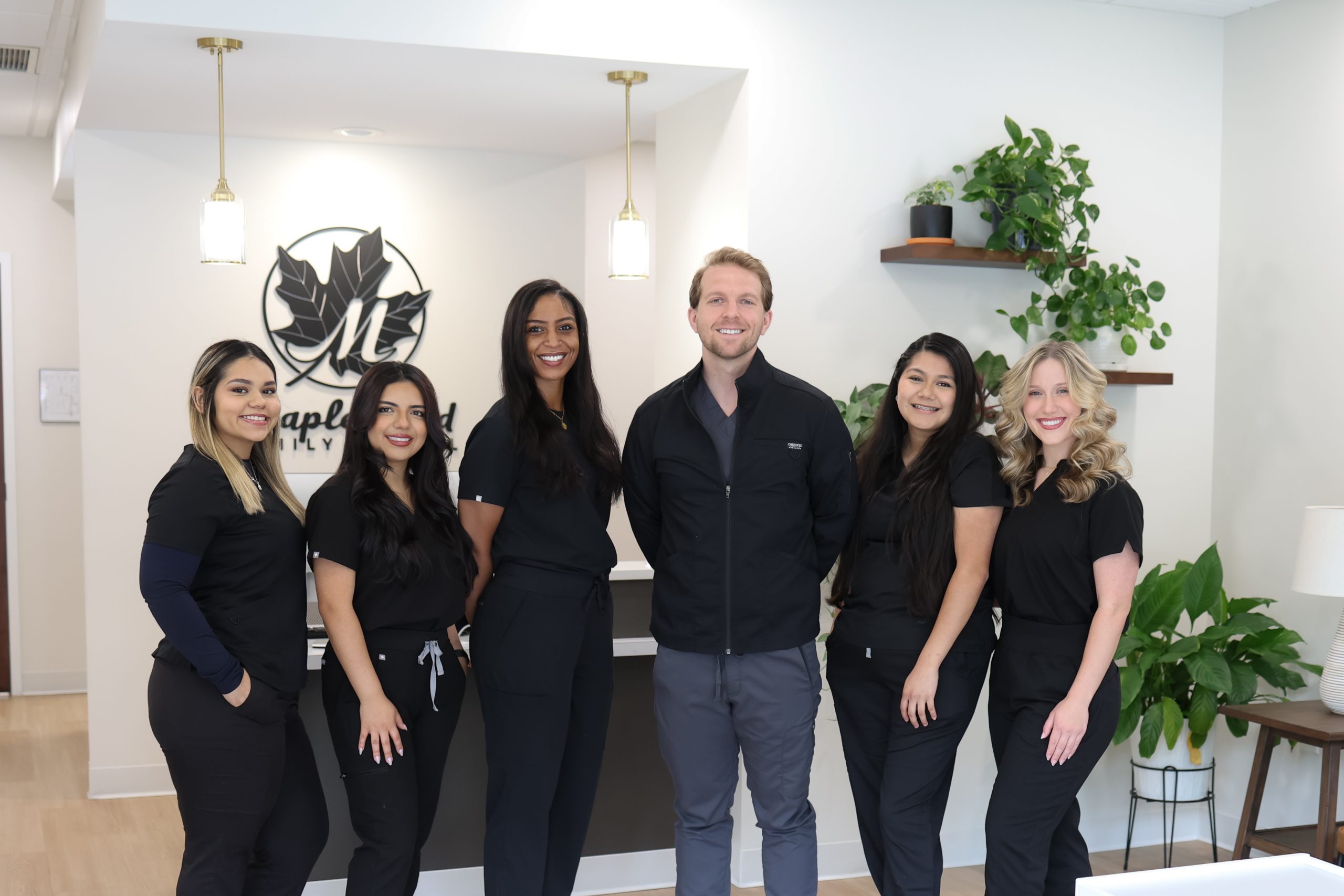 Professional dental team standing together in a modern clinic room, representing trusted family dental care in Knightdale NC – dentist knightdale nc